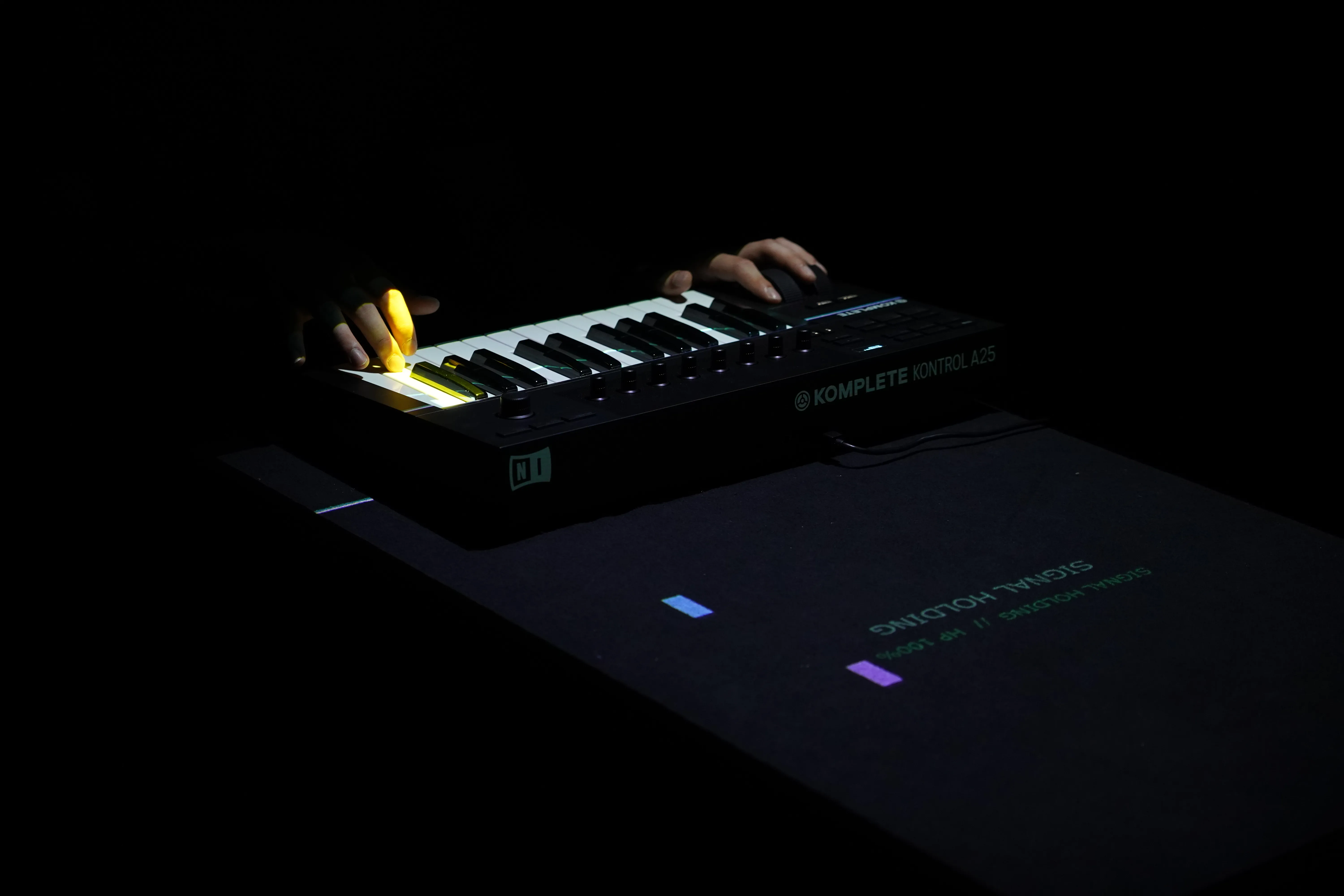 Visitor playing the MIDI keyboard beneath the projected interface
